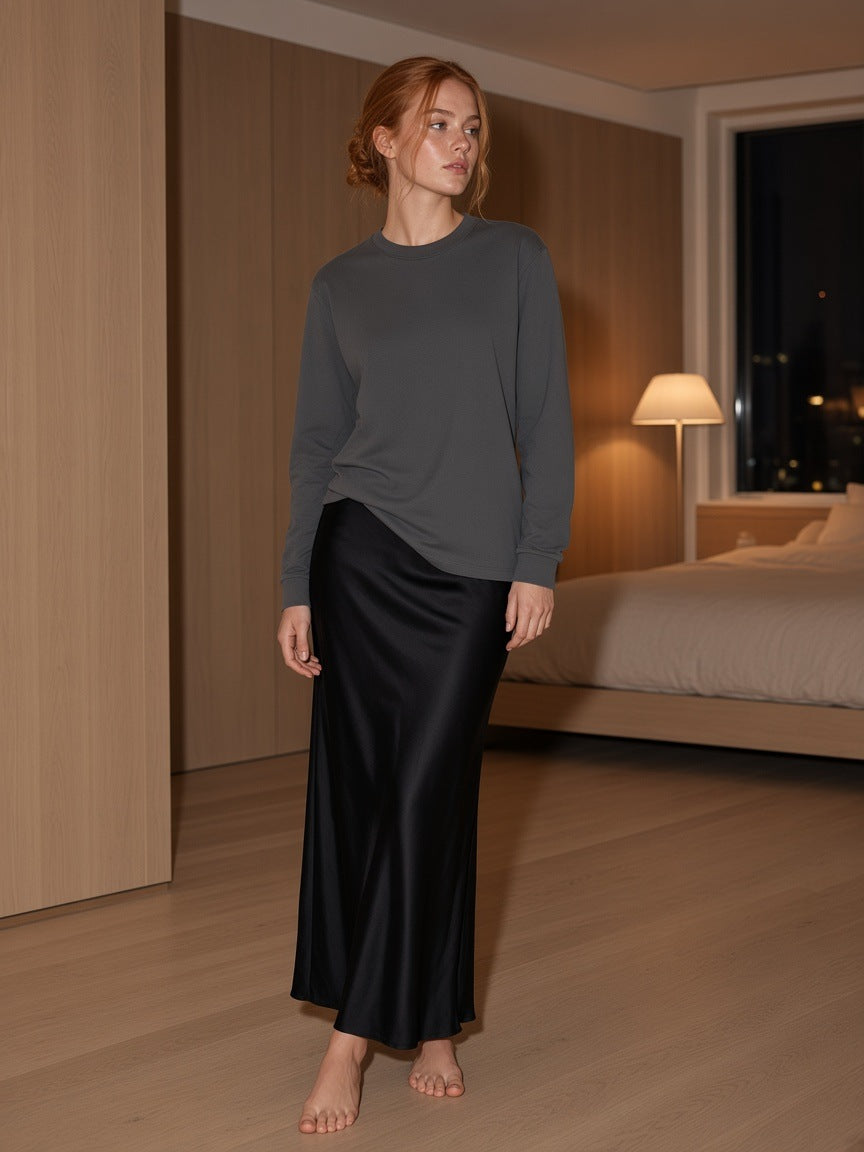 Marcel Afters Crew Neck Drop Shoulder Long Sleeve Shirt in Dark Gray, worn by a woman, bedroom