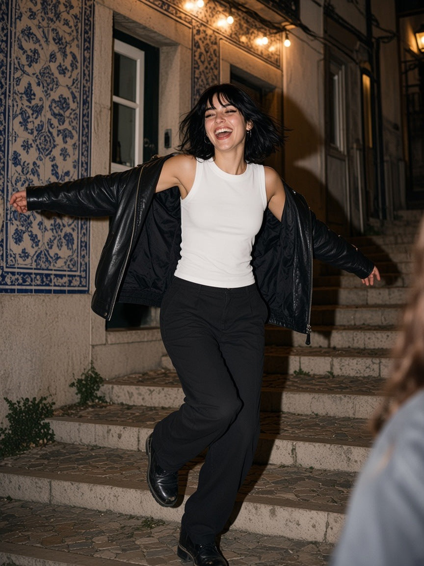 Woman in the Women's Crewneck Tank Top in White, spinning on an Alfama stairway in Lisbon at 1am