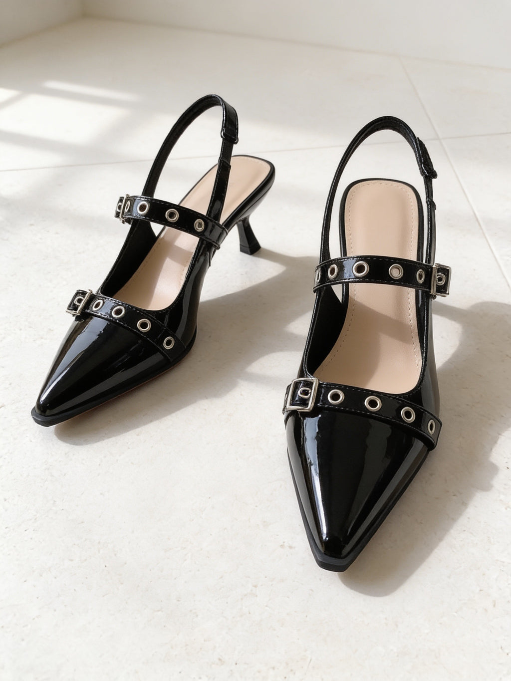 The Do Not Disturb Slingback in Black, pair on pale limestone