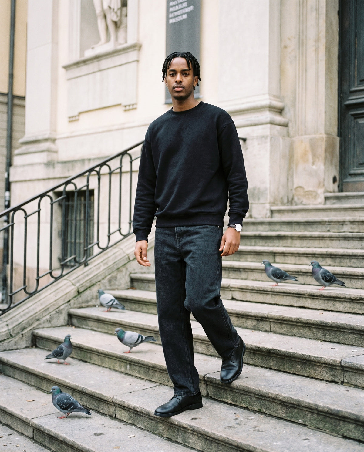 Man wearing the Marcel Afters Drop Shoulder Crewneck Sweatshirt, Dark Tones in Black, full-length editorial photograph