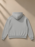 Drop shoulder full-zip hoodie in Flower Gray, laid flat on pale limestone, back view