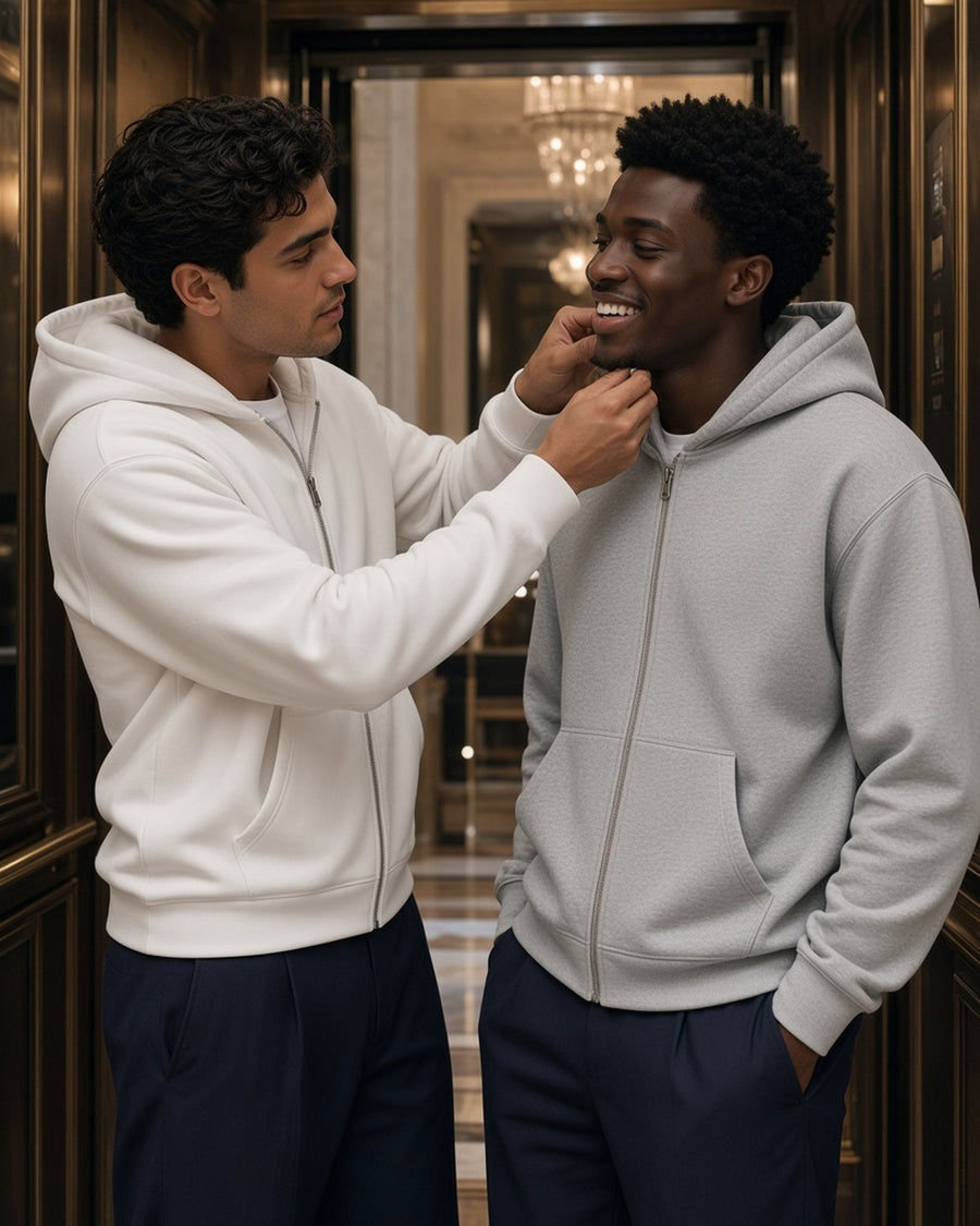 Two men in the Drop Shoulder Full Zip Hoodie in White and Flower Gray in a grand-hotel lift