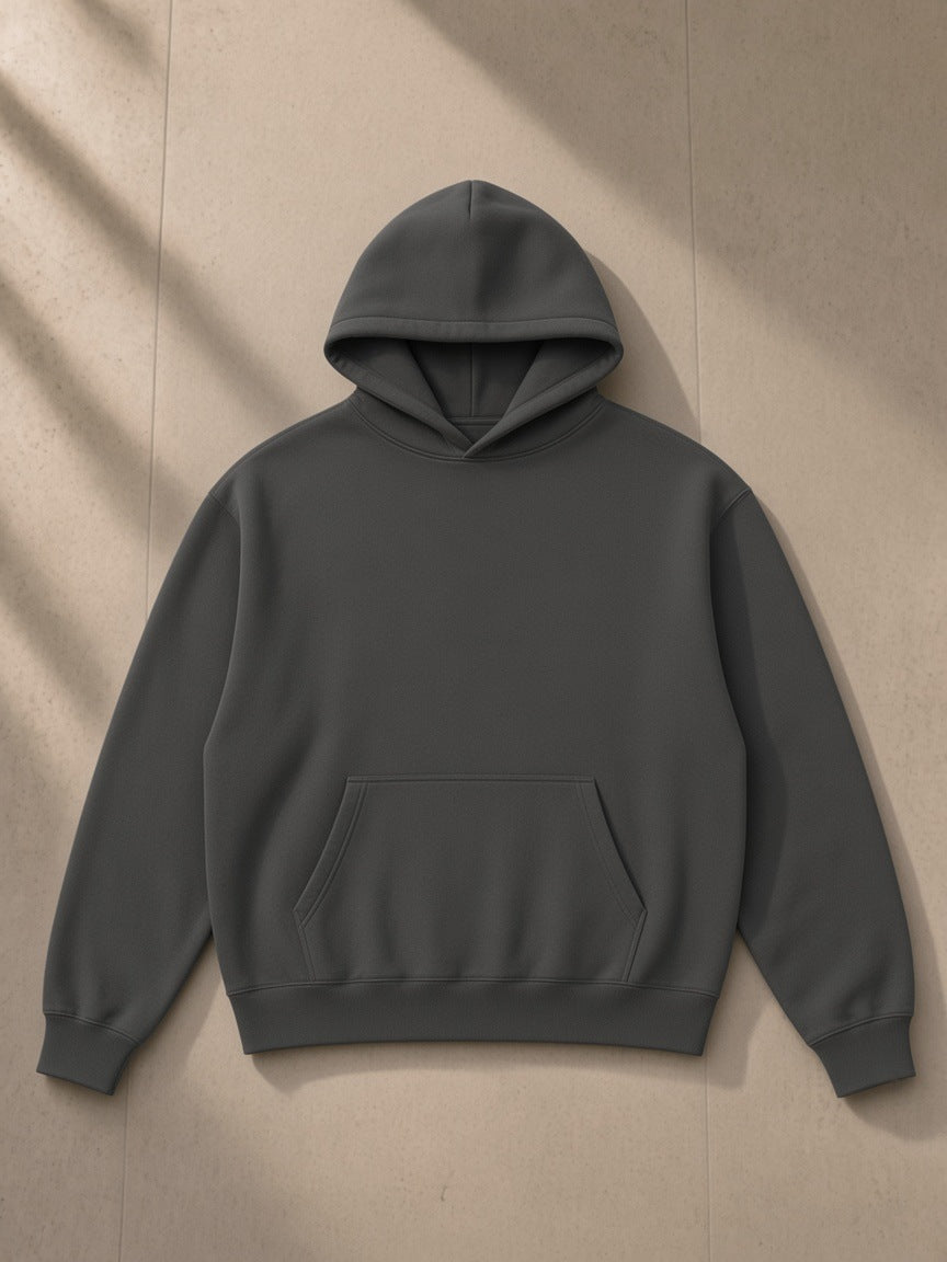 Drop Shoulder Hoodie in Dark Gray, laid flat on pale limestone, front view