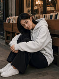Model wearing the Drop Shoulder Hoodie in Flower Gray, full-length model photo
