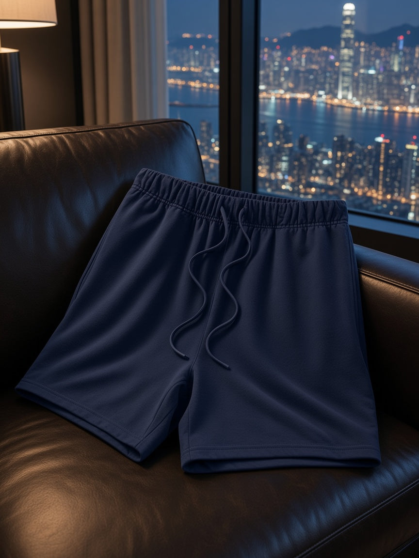 Marcel Afters Earth Tone Loose Fit Cotton Shorts in Navy, laid flat, city