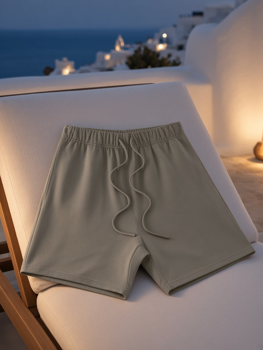 Marcel Afters Earth Tone Loose Fit Cotton Shorts in Gray Green, laid flat, outdoor