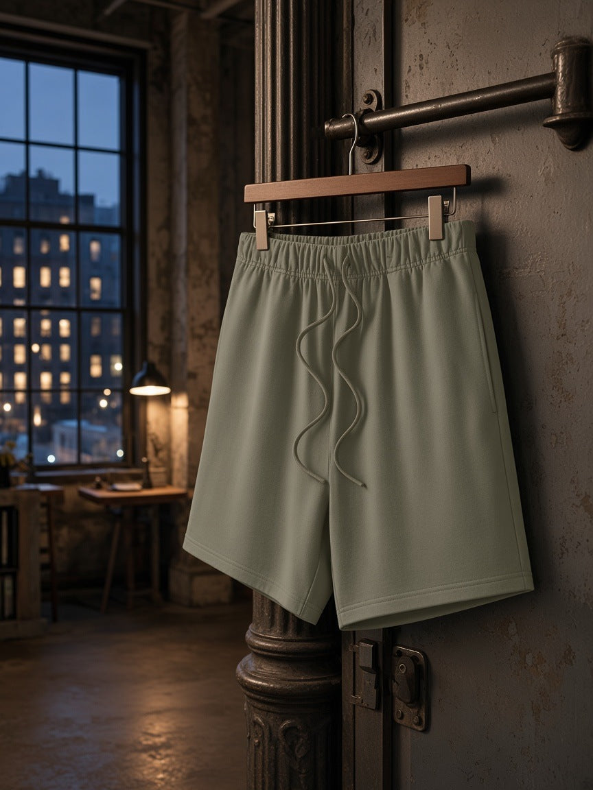 Marcel Afters Earth Tone Loose Fit Cotton Shorts in Gray Green, laid flat, industrial