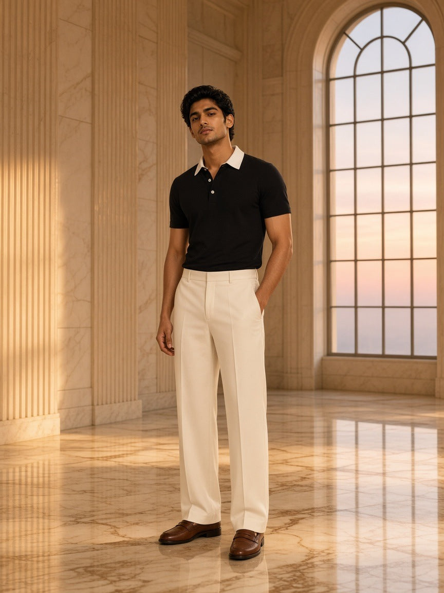 Marcel Afters Essential Contrast Polo Shirt in Black, worn by a man, standing in a marble hall with arched windows at sunset