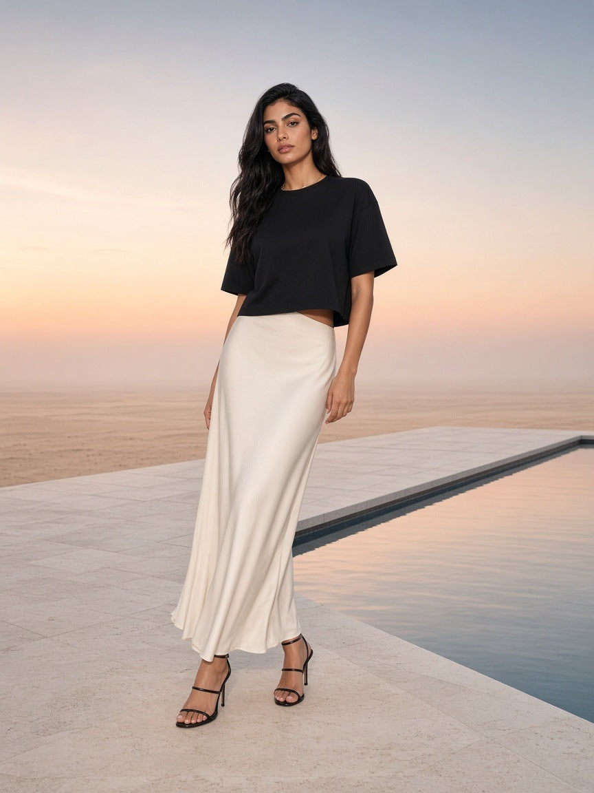 Marcel Afters Essential Cotton Boxy T-Shirt in Black, worn by a woman, beach