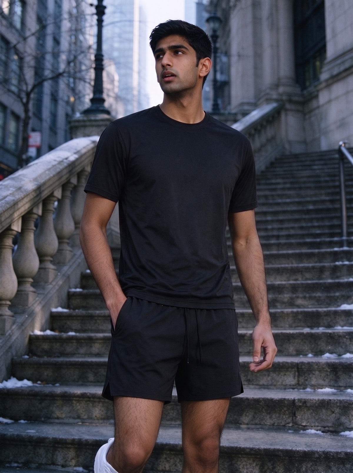 Man wearing the Marcel Afters Essential Cotton T-Shirt, Dark Tones in Black, full-length editorial photograph