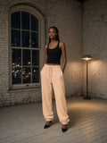 Woman wearing the Essential Heavyweight Cotton Sweatpants in Apricot, full-length model photo