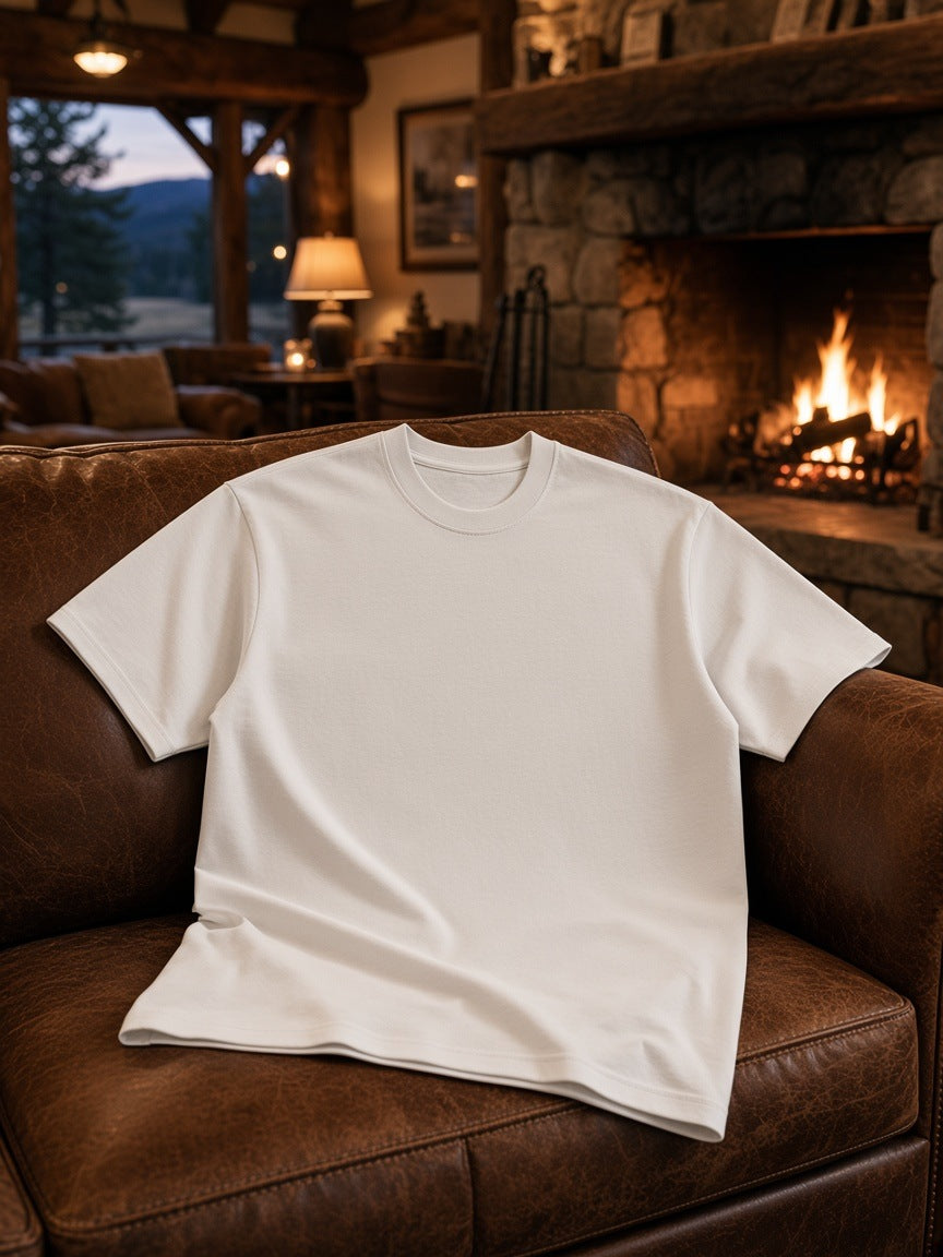 Marcel Afters Essential Heavyweight Cotton T-Shirt in White, laid flat, living room