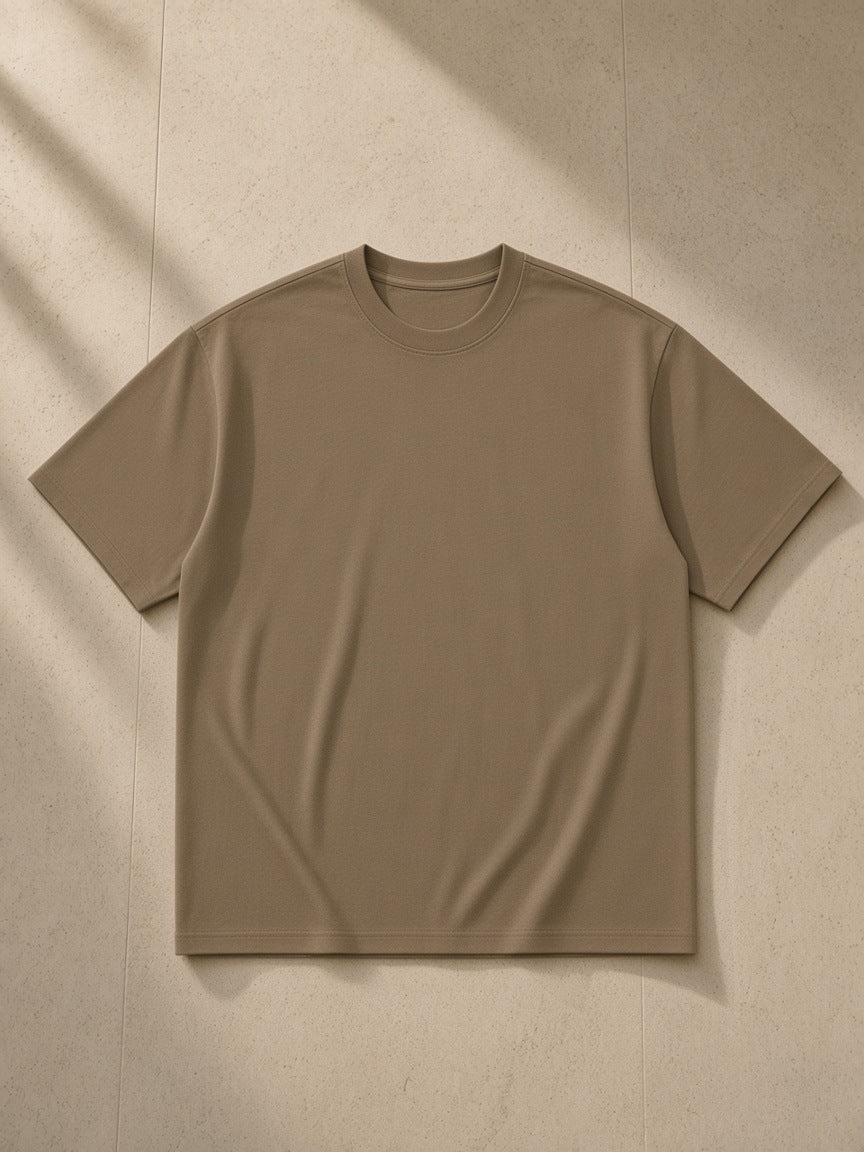 Essential Heavyweight Cotton T-Shirt in Mocha Brown, laid flat on pale limestone