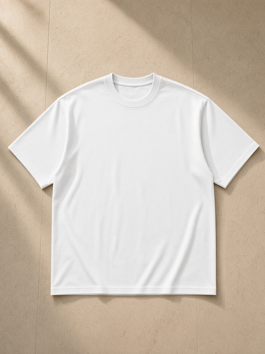 Essential Heavyweight Cotton T-Shirt in White, laid flat on pale limestone