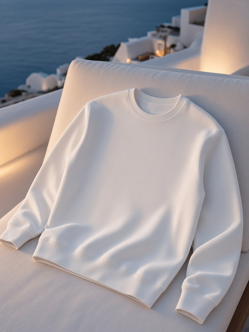 Marcel Afters Essential Heavyweight Crewneck Sweatshirt, 400 gsm in White, laid flat, white couch