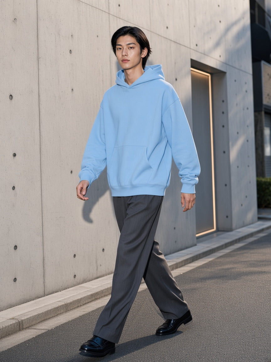 Man wearing the Essential Heavyweight Drop-Shoulder Hoodie in Sky Blue, full-length model photo