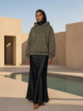 Model wearing the Essential Heavyweight Fleece Hoodie in Olive Green, full-length model photo