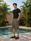 Man wearing the Essential Heavyweight Fleece Shorts in Olive Green, full-length model photo