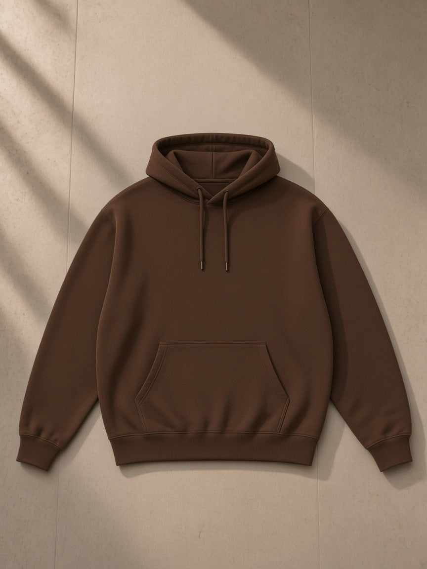 Essential heavyweight hoodie in Coffee, laid flat on pale limestone, front view