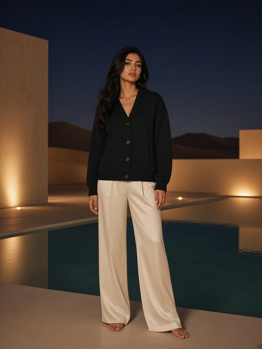 Marcel Afters Essential Heavyweight Sweat Cardigan in Black, worn by a woman, outdoor