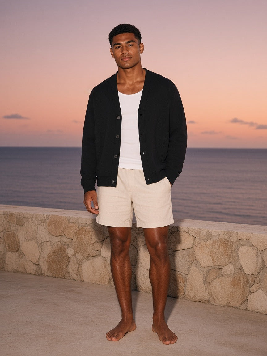 Marcel Afters Essential Heavyweight Sweat Cardigan in Black, worn by a man, ocean