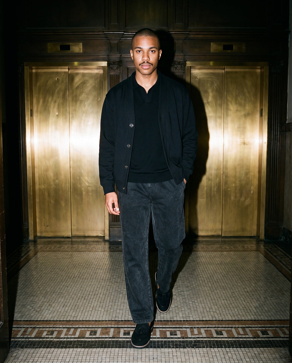 Man wearing the Marcel Afters Essential Heavyweight Sweat Cardigan, Dark Tones in Black, full-length editorial photograph
