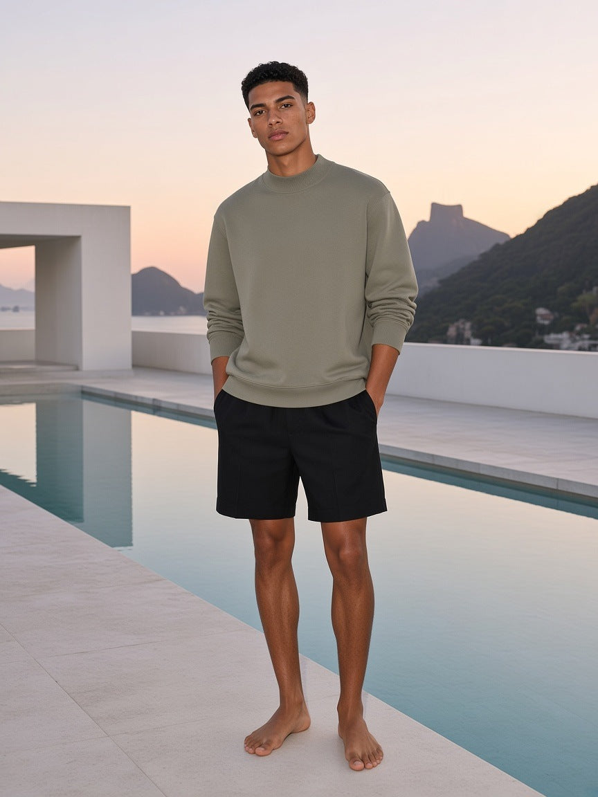 Marcel Afters Essential Non-Shrink Mock Neck Sweatshirt in Gray Green, worn by a man, rooftop
