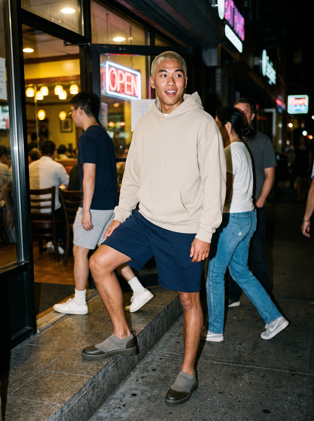 Friends together, one wearing the Marcel Afters Essential Oversized Hoodie, Light Tones in Beige