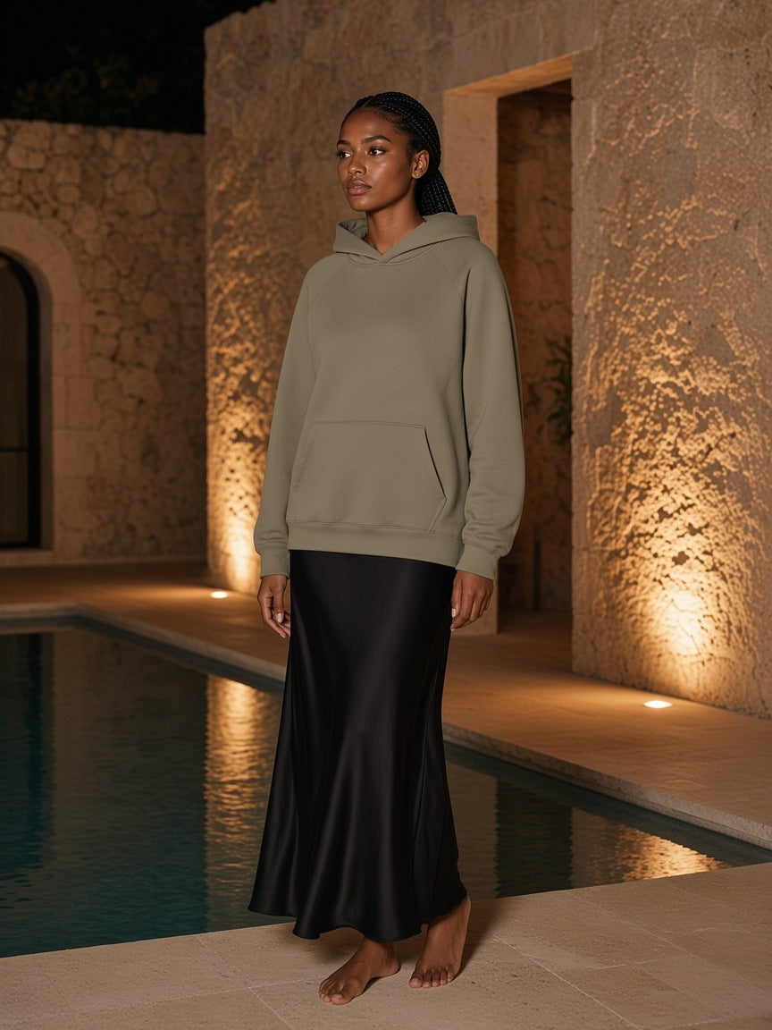 Marcel Afters Essential Raglan Sleeve Fleece Hoodie in Cement Gray, worn by a woman, poolside