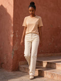 Woman wearing the Essential Standard Shoulder T-Shirt in Mild Apricot, full-length model photo
