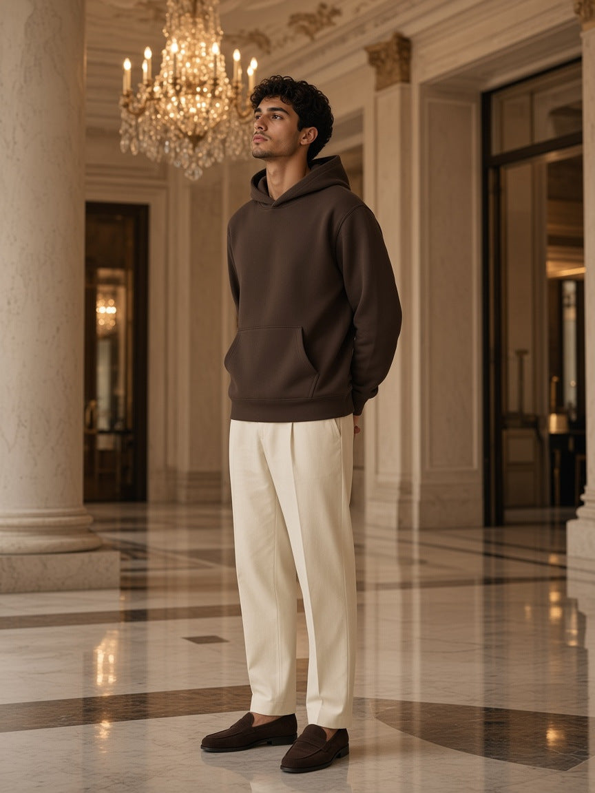 Marcel Afters Fleece Regular Shoulder Hoodie in Coffee, worn by a man, standing in a marble hotel lobby
