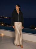 Marcel Afters Fleece Zip-Up Boxy Hoodie in Black, worn by a woman, night
