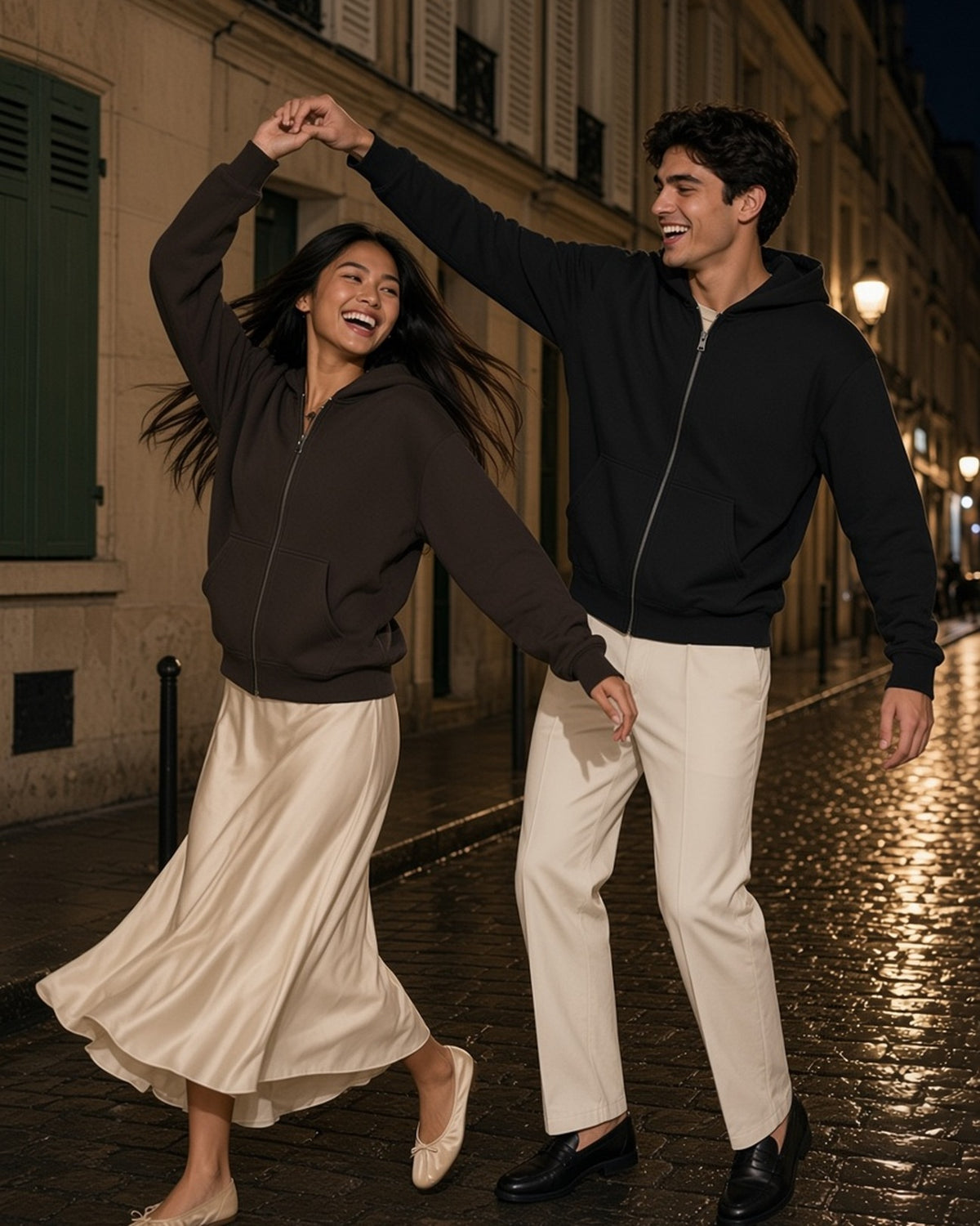 Two people in the Fleece Zip-Up Boxy Hoodie in Brown and Black, dancing on a Paris street at night