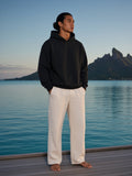 Marcel Afters Fleeced Boxy Hoodie in Black, worn by a man, ocean