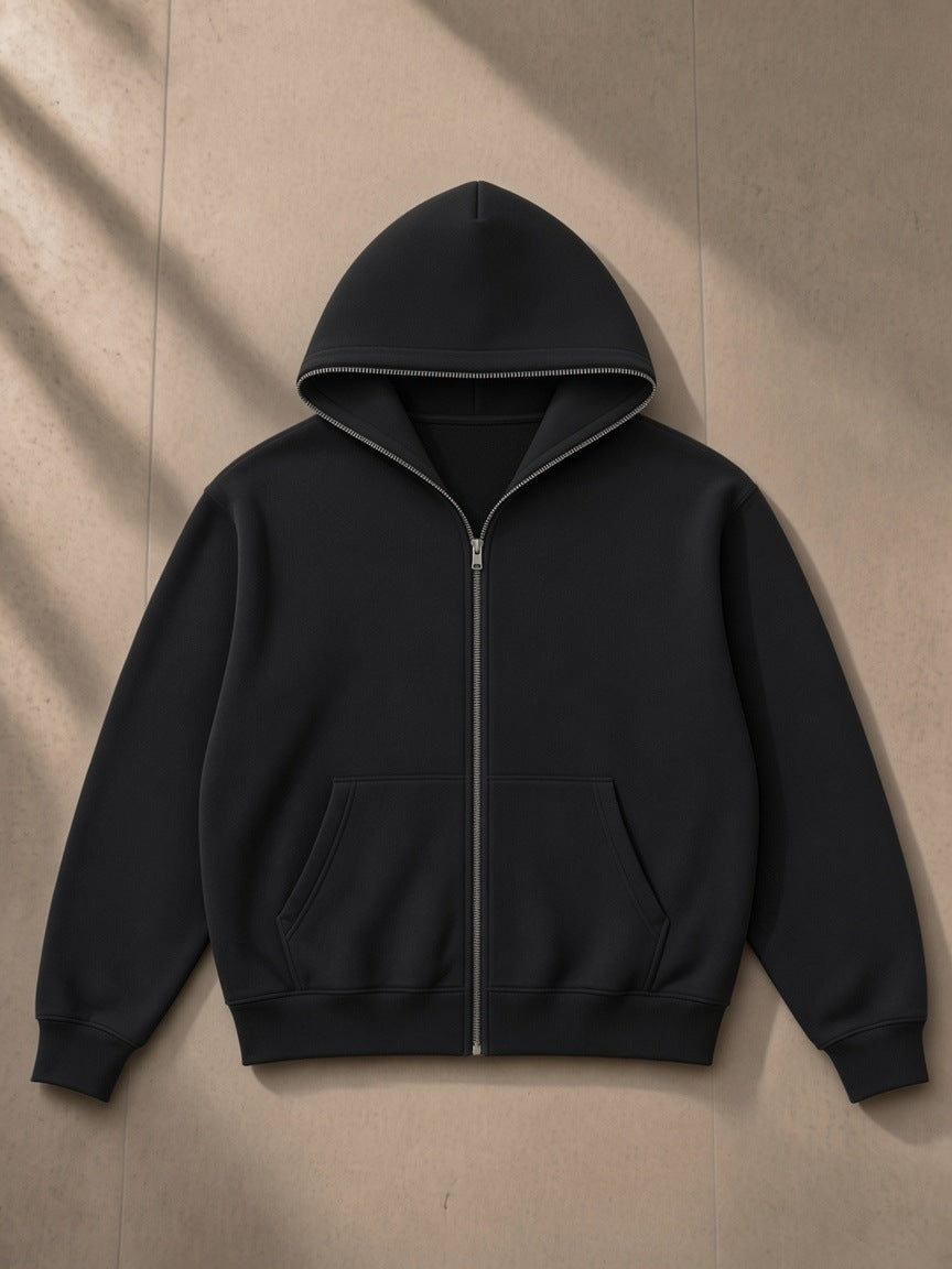Men's fleeced full-zip boxy hoodie in Black, laid flat on pale limestone, front view