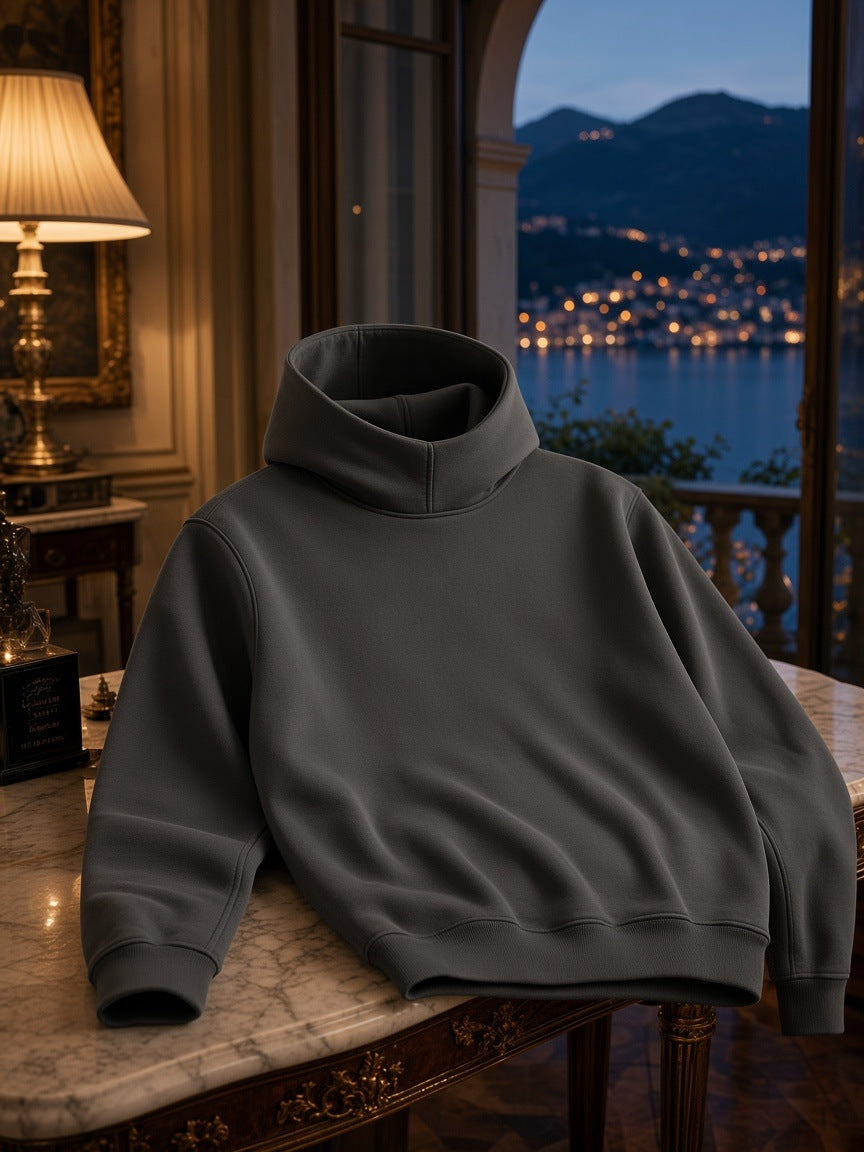 Marcel Afters Fleeced High Neck Hoodie in Dark Gray, laid flat, in a room with a view of a lake