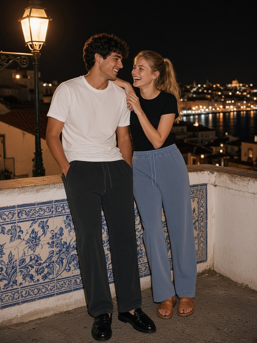 Marcel Afters Frayed Enzyme Washed Fleece Sweatpants in Black, worn by a man, city at night