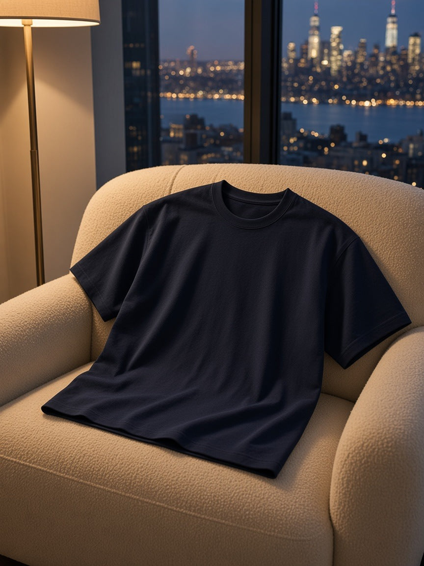 Marcel Afters Heavyweight Drop Shoulder Cotton T-Shirt in Navy, laid flat, city