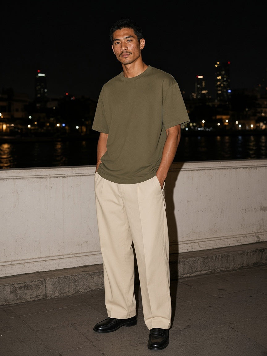 Marcel Afters Heavyweight Drop Shoulder Cotton T-Shirt in Khaki, worn by a man, city