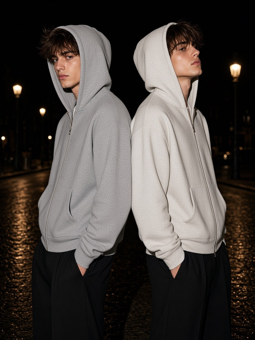 Two people back to back on a wet Paris street at night in the Heavyweight Full Zip Hoodie in Flower Gray and Oat Gray