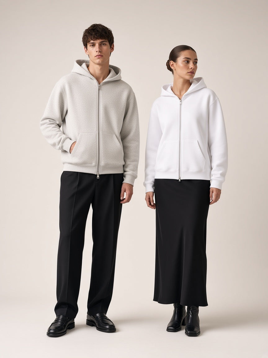 Two people in the Heavyweight Full Zip Hoodie in Oat Gray and White, standing apart in a bone paper studio, 420 gsm fleece with silver zip