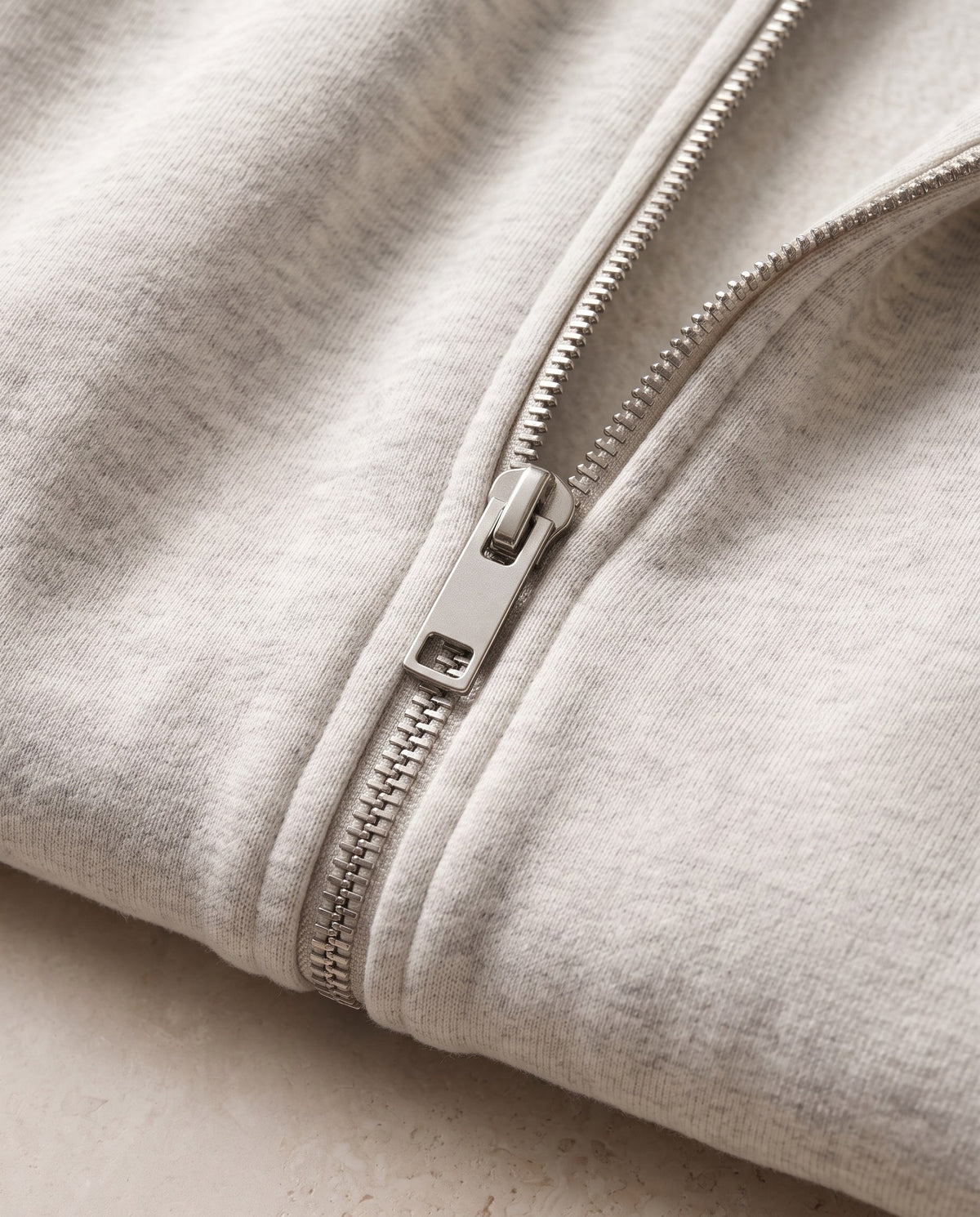 Close-up of the silver zip pull and heavyweight 420 gsm fleece on the Heavyweight Full Zip Hoodie