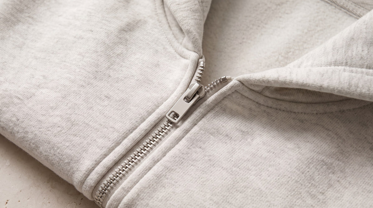 Close-up of the zip and neckline on the Heavyweight Full Zip Hoodie in Oat Gray