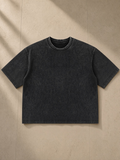Heavyweight Mineral Wash Boxy T-Shirt in Black, laid flat on pale limestone