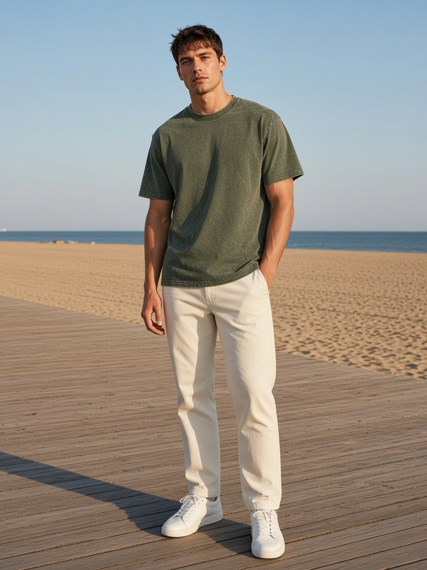 Marcel Afters Heavyweight Snow Washed T-Shirt in Olive Green, worn by a man, beach