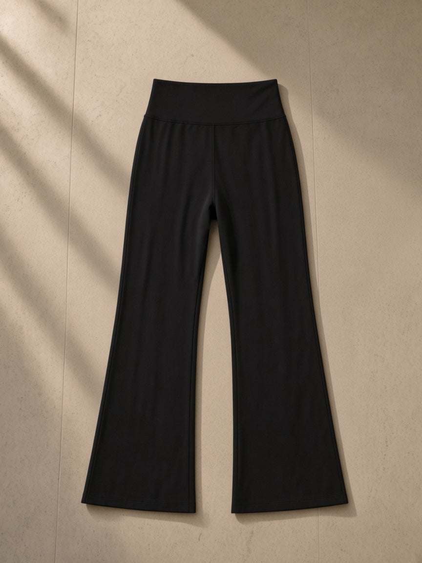 Women's High-Waisted Flare Leggings in Black, laid flat on pale limestone, front view