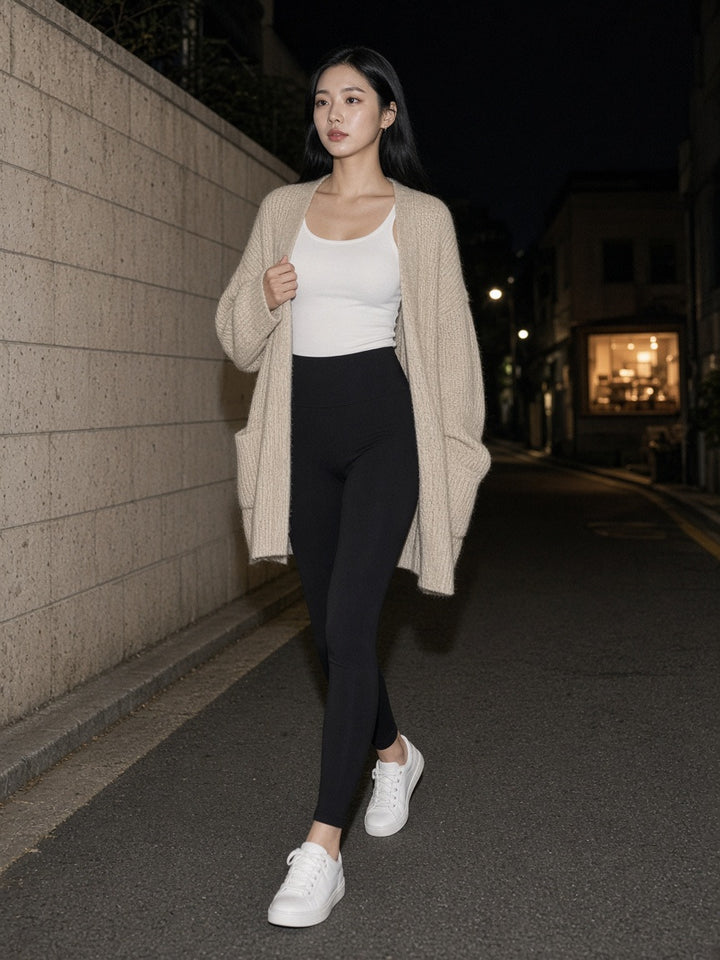 Woman wearing the High-Waisted Yoga Leggings in Black, full-length model photo