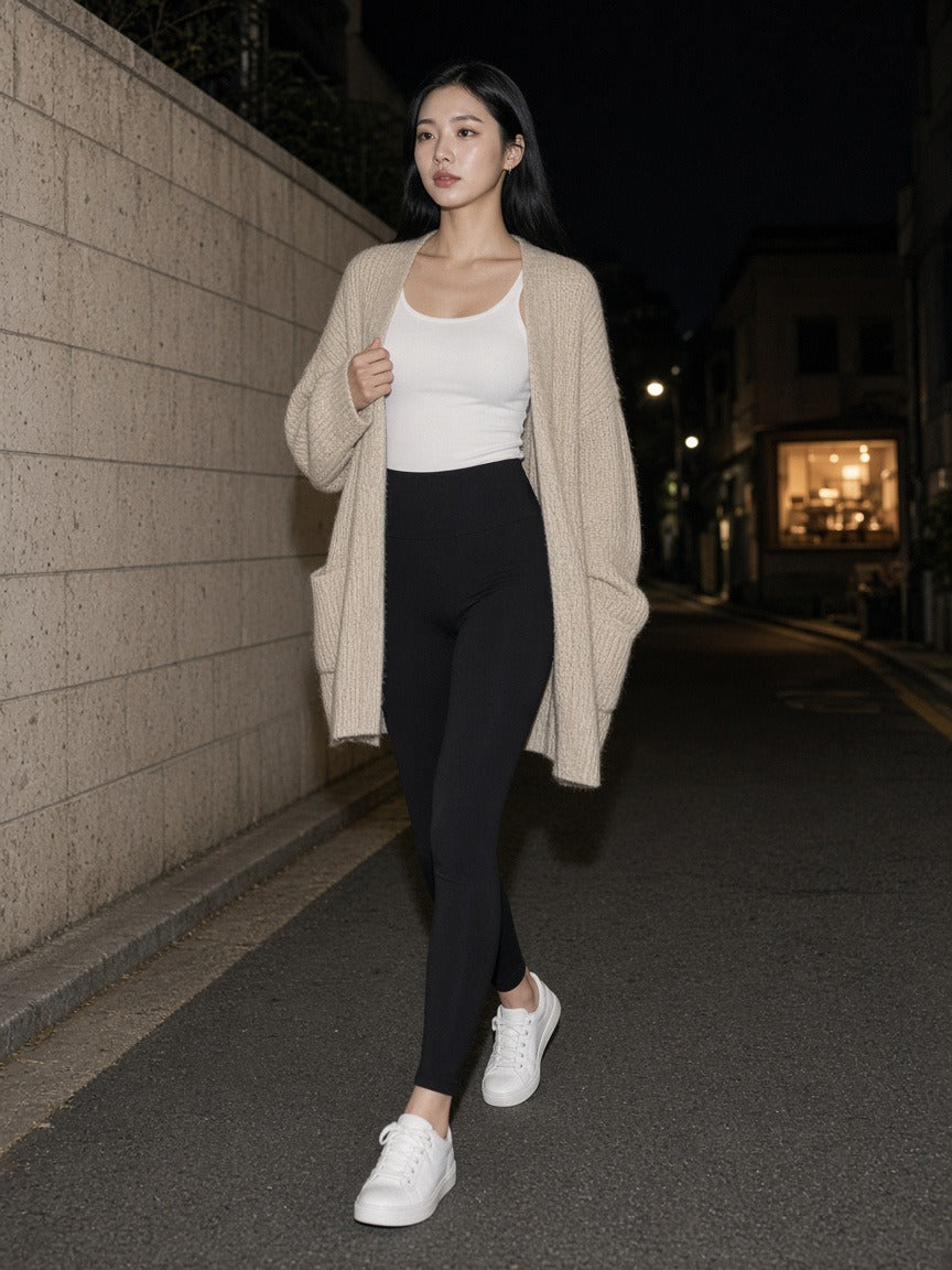 Woman wearing the High-Waisted Yoga Leggings in Black, full-length model photo