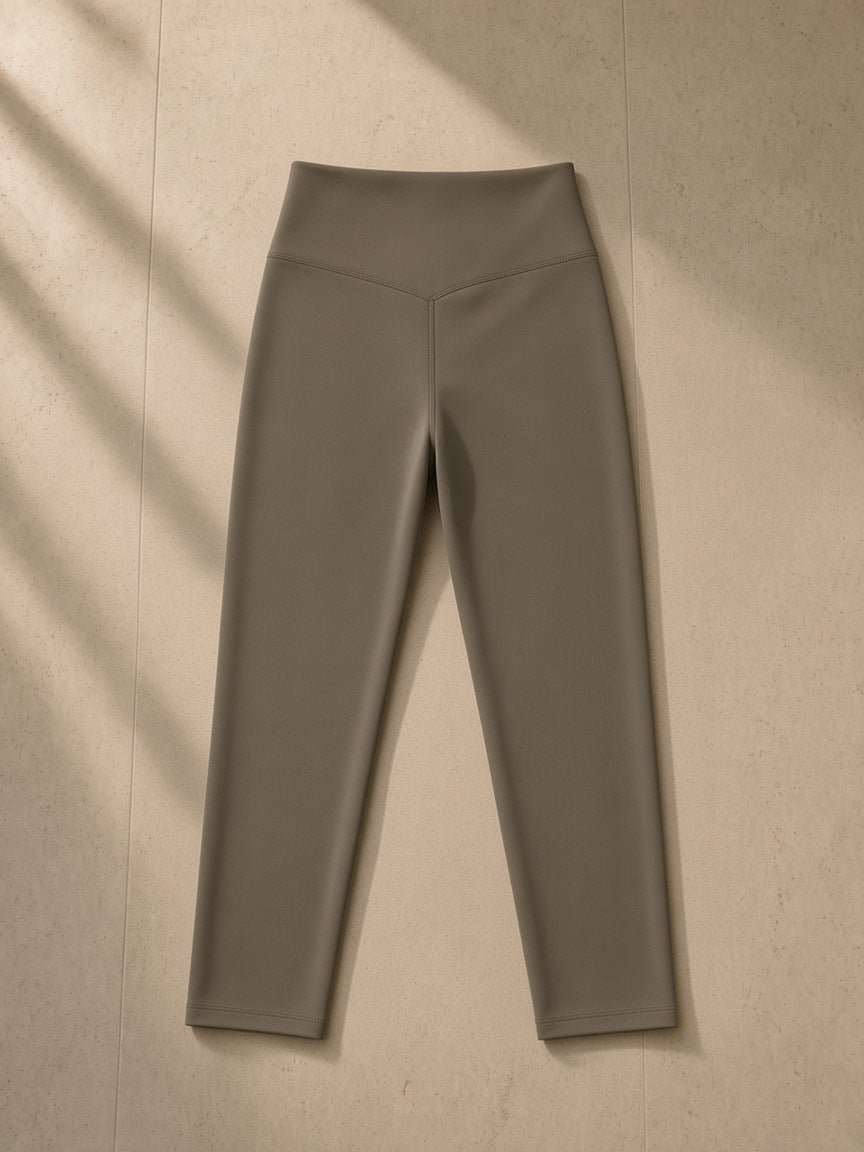 High-Waisted Yoga Leggings in Gray Coffee, laid flat on pale limestone, back view
