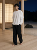 Marcel Afters Layered Oversized T-Shirt in White, worn by a man, wooden room